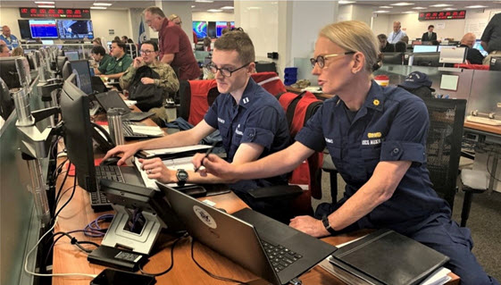 From left: LT Christopher Bodner, (CG-MER CGHQ) and Auxiliarist Renee Thomas were assigned as ESF-10 Technical Specialists & Liaison Officers to FEMA’s National Response Coordination Center (NRCC) for Hurricane Dorian. Photo provided by Auxiliarist Renee Thomas.